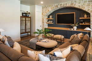 Living room with dark wood finished floors and baseboards