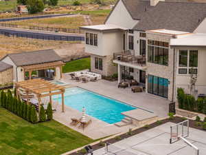View of swimming pool featuring a patio, outdoor lounge area, a pergola, and a balcony