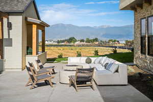 View of patio with a fire pit and a mountain view
