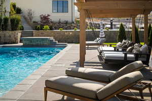 Outdoor pool with a patio area, outdoor lounge area, and stairs
