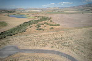 Aerial view of property's location featuring a mountain backdrop and rural landscape