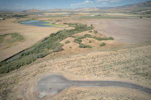 Aerial view of property and surrounding area with a water and mountain view and rural landscape