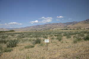 View of mountain backdrop with rural landscape