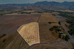 Aerial overview of property's location with property parcel outlined and rural landscape