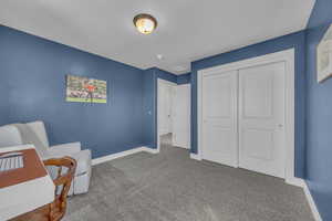 Living area with carpet floors and baseboards