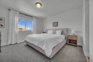 Carpeted bedroom featuring baseboards
