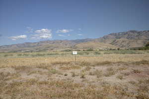 View of mountain backdrop with rural landscape