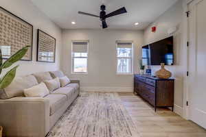 Living room featuring light wood-style floors, recessed lighting, and ceiling fan