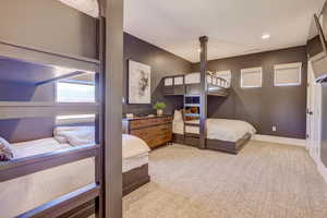 Bedroom featuring light carpet, multiple windows, and recessed lighting