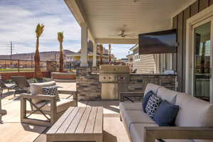 View of patio / terrace featuring an outdoor kitchen, outdoor lounge area, and a ceiling fan
