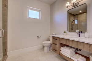 Full bathroom featuring vanity, a shower stall, and light tile patterned floors