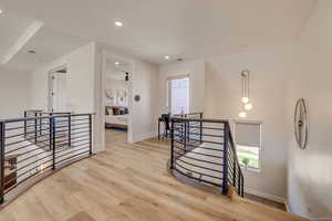 Stairs with recessed lighting and wood finished floors