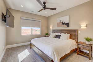 Bedroom with a ceiling fan, recessed lighting, and light carpet