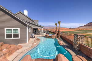 View of swimming pool with a fenced backyard, a patio, a mountain view, and a pool with connected hot tub