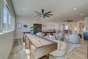 Rec room with light wood finished floors, a ceiling fan, and recessed lighting