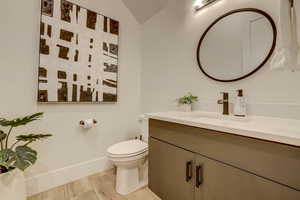 Half bath with vanity and light wood-type flooring