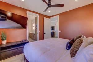 Bedroom featuring recessed lighting, light wood-style floors, a ceiling fan, and connected bathroom