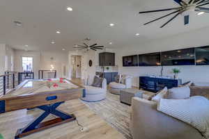 Playroom with ceiling fan, recessed lighting, and wood finished floors