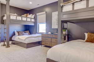 Bedroom featuring light colored carpet