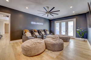 Cinema room featuring french doors, recessed lighting, light wood-style floors, and ceiling fan