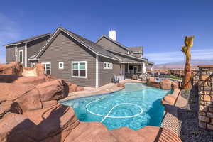 View of swimming pool with an in-ground hot tub, a patio, a fenced backyard, and a mountain view
