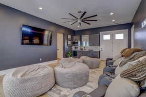 Living area featuring light wood-style floors, recessed lighting, and ceiling fan