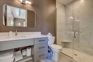 Bathroom with a stall shower and vanity