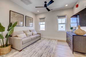 Living area with light wood-style floors, recessed lighting, and ceiling fan