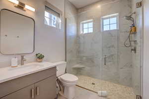 Full bathroom with a stall shower, healthy amount of natural light, and vanity