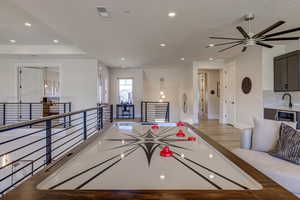 Playroom featuring recessed lighting, light wood-style flooring, a chandelier, and ceiling fan
