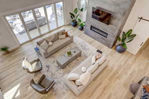 Living room with wood finished floors and a tiled fireplace