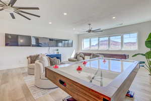 Game room with light wood-type flooring, recessed lighting, and a ceiling fan