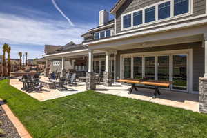 Rear view of property featuring a patio area and a lawn
