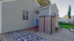 Wooden deck featuring a shed