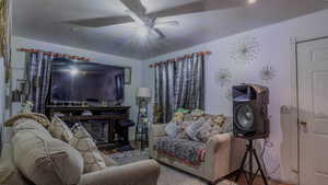 Living room featuring wood finished floors and a ceiling fan