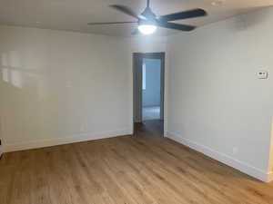 Spare room featuring light wood-style floors and ceiling fan