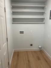 Washroom featuring light wood finished floors, hookup for a washing machine, and hookup for an electric dryer