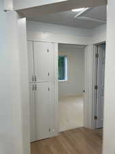 Hall featuring light wood finished floors