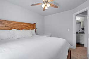 Bedroom featuring light colored carpet and a ceiling fan
