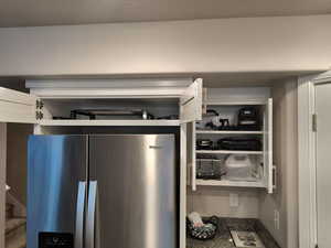 Detailed view of stainless steel refrigerator with ice dispenser