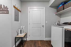 Laundry area with dark wood-style floors, independent washer and dryer, and electric panel