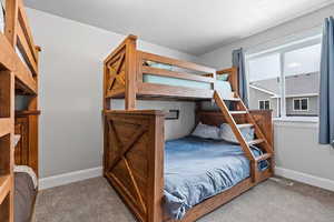 Bedroom with baseboards and carpet floors
