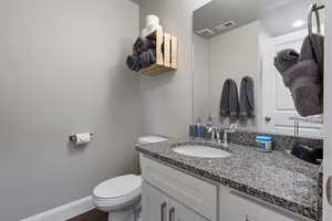 Bathroom featuring vanity and toilet