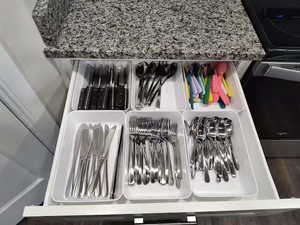 Kitchen view of dishwashing machine and electric stove