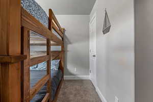 Corridor featuring baseboards and carpet