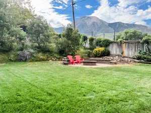 View of yard with a patio, a fire pit, and a mountain view