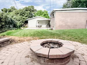 View of patio with an outdoor fire pit