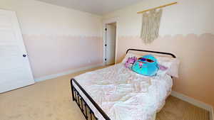 Bedroom with light colored carpet and baseboards