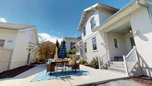 View of patio featuring outdoor dining area and ceiling fan