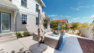 Fenced backyard featuring a patio area, an outdoor hangout area, and outdoor dining area